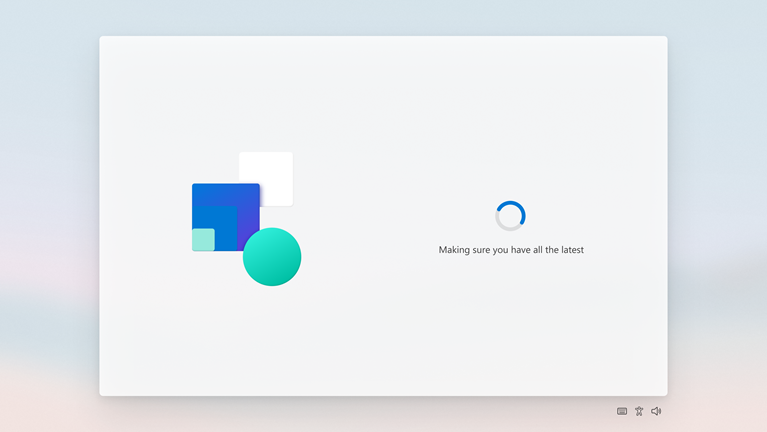 The out-of-box experience screen showing a spinning progress circle and the text Making sure you have all the latest
